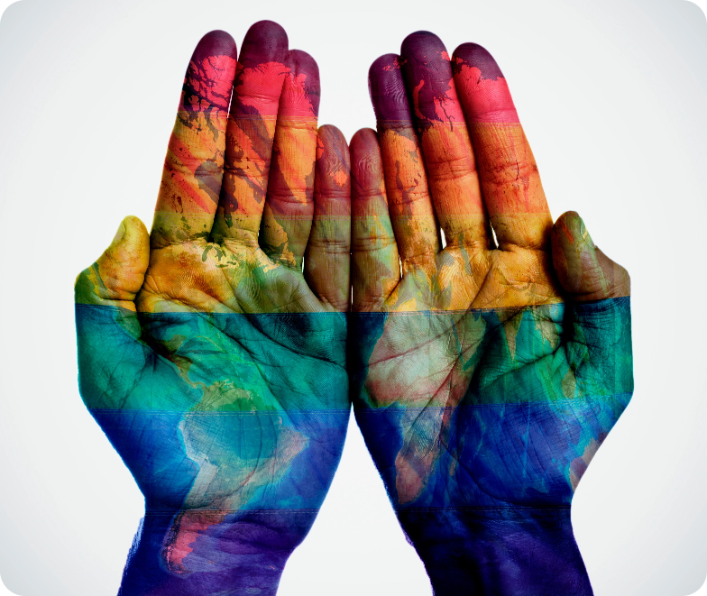 Two hands painted with a world map in rainbow colors, held together, symbolizing Human Rights.