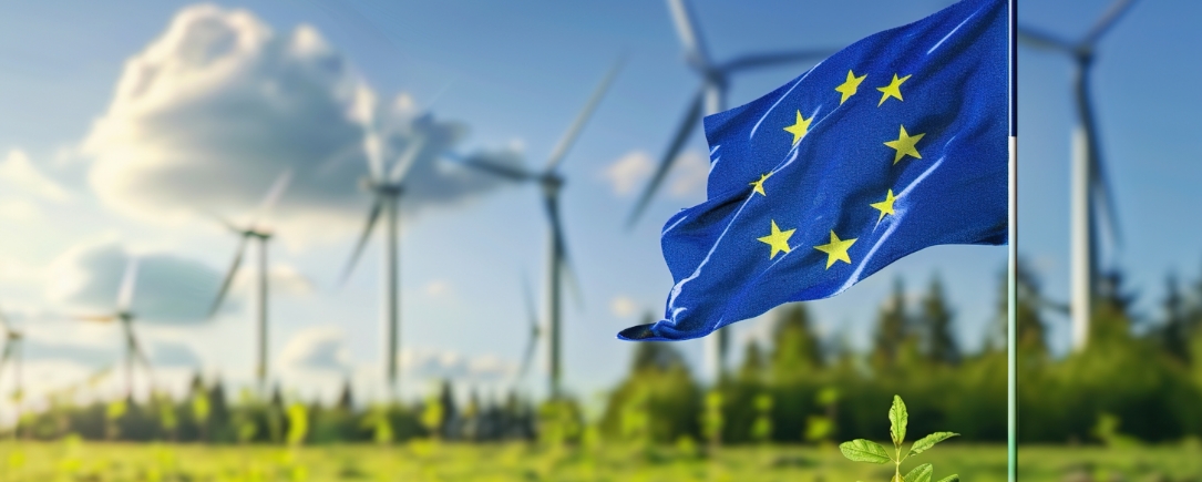 European Union flag with wind turbines in the background, symbolizing sustainability and renewable energy.